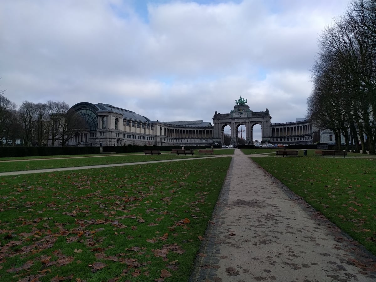 Arco triunfal del Parque del Cincuentenario de Bruselas entre árboles desnudos de invierno