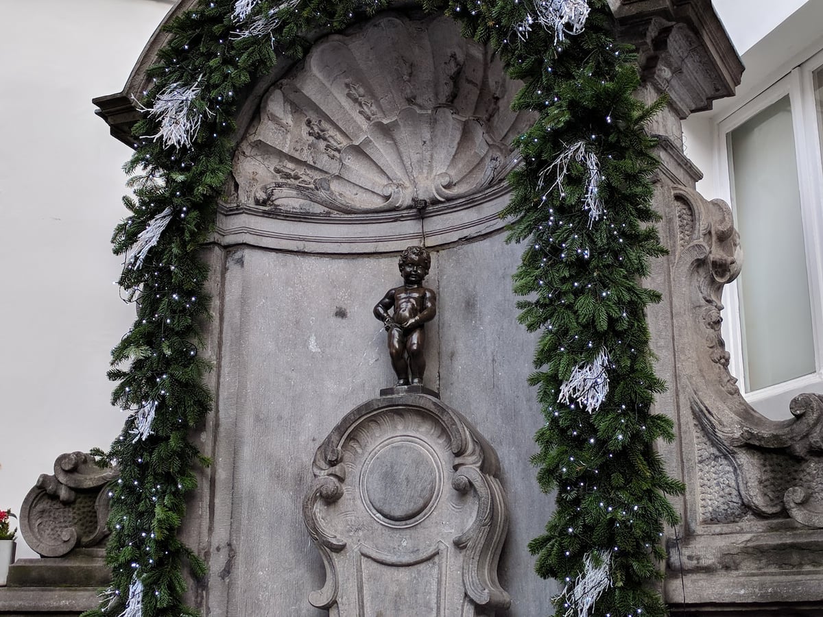 Turistas fotografiando la fuente del Manneken Pis en Bruselas
