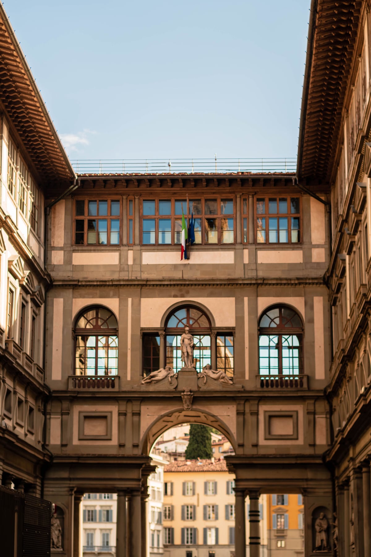 Vista del patio de la Galería Uffizi con arcos arquitectónicos en Florencia, Italia.