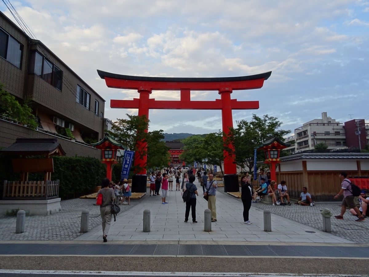 El túnel de toriis bermellón de Fushimi Inari subiendo por la ladera del monte, con la luz de última hora de la tarde entrando entre los portones.